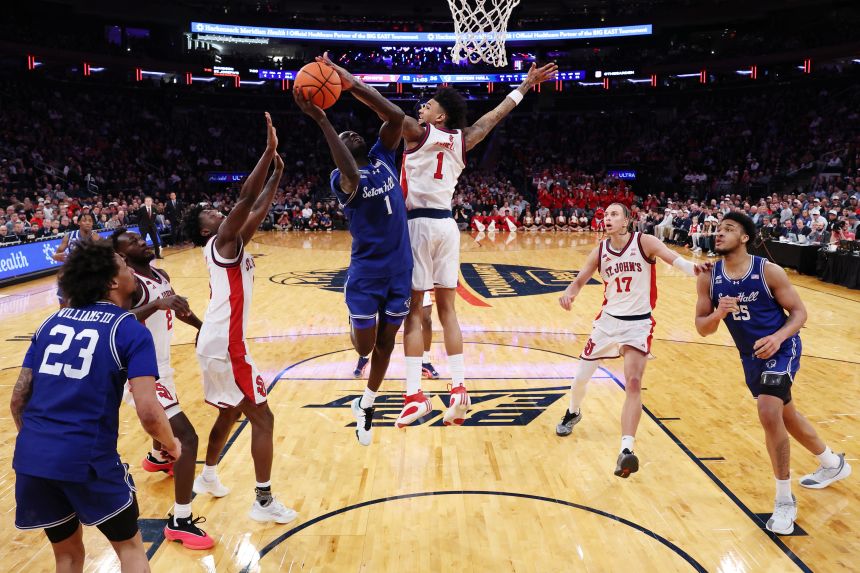 Jacob Dar #1 of the Seton Hall Pirates goes to the basket as Dillon Mitchell #1 of the St. John's Red Storm defends during the 2026 Big East Men's Tournament - Semifinal game at Madison Square Garden on March 13, 2026 in New York City.