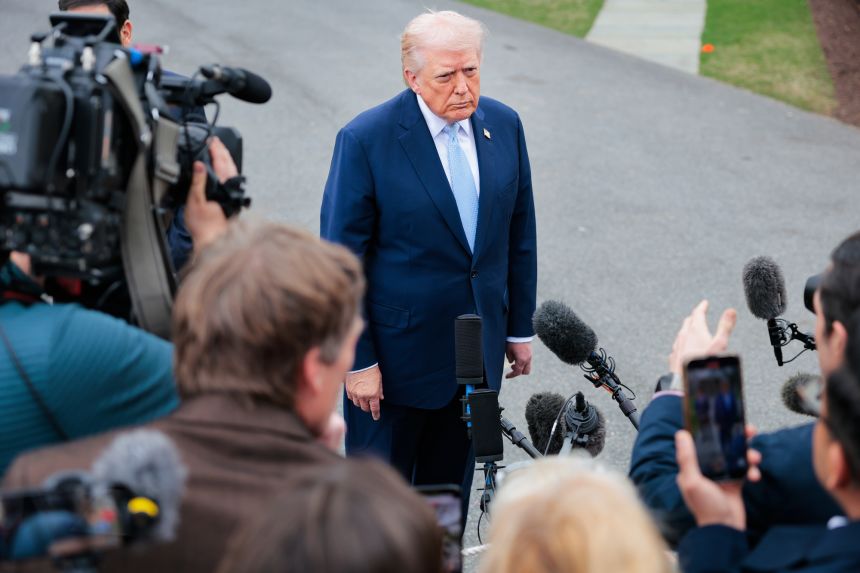 President Donald Trump stops to speak to reporters as he departs the White House on March 20, 2026.