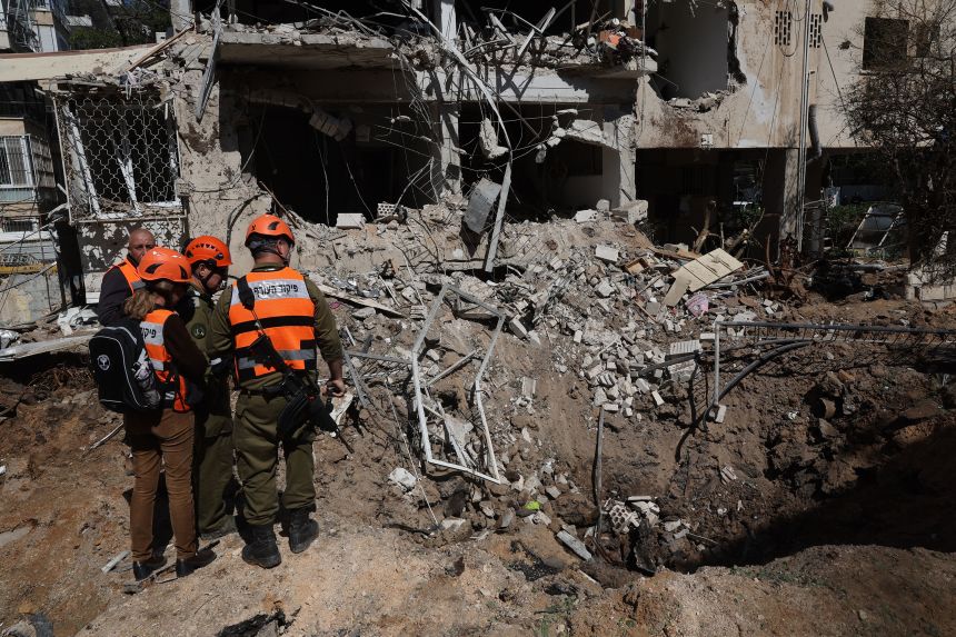 Israeli emergency service personnel gather at the site of an Iranian missile strike in Tel Aviv on Tuesday, March 24.