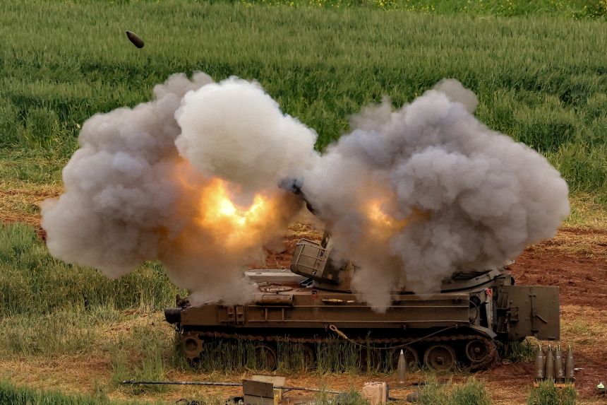 An Israeli self-propelled howitzer artillery gun fires rounds towards southern Lebanon from a position in the upper Galilee in northern Israel.