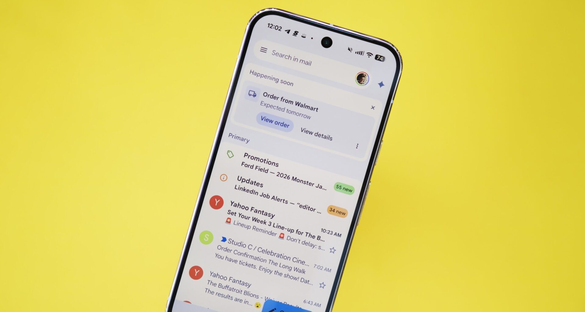 The Gmail app running on a Pixel phone, with a yellow background behind it.