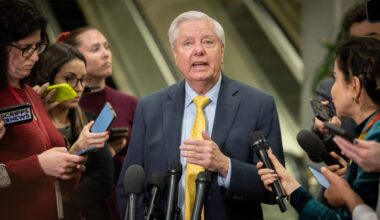 A photo of Graham speaking with reporters.