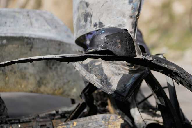 Helmet A burned press helmet rests on the charred car that was carrying Hezbollah's al-Manar TV correspondent Ali Shoeib, Beirut's based Al-Mayadeen TV reporter Fatima Ftouni and her brother, video journalist Mohammed Ftouni, before they were killed in an Israeli airstrike, in the town of Jezzine, south Lebanon, Saturday, March 28, 2026.
