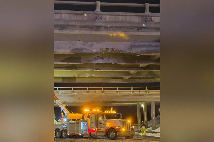 Cleanup crew at work at Highway 11 overpass after a semi-truck crashed into the overpass.