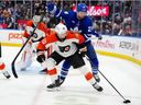 Toronto Maple Leafs Scott Laughton (24) and Philadelphia Flyers Bobby Brink (10) vie for control of the puck during second period NHL hockey action in Toronto, Monday, March 2, 2026.