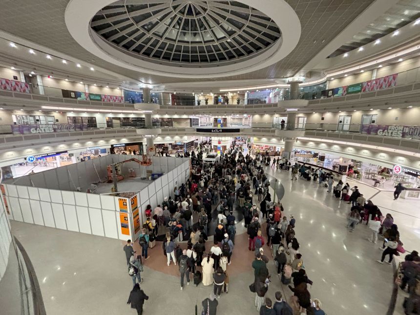 Passengers wait in long lines at Hartsfield-Jackson Atlanta International Airport early Friday, March 20.
