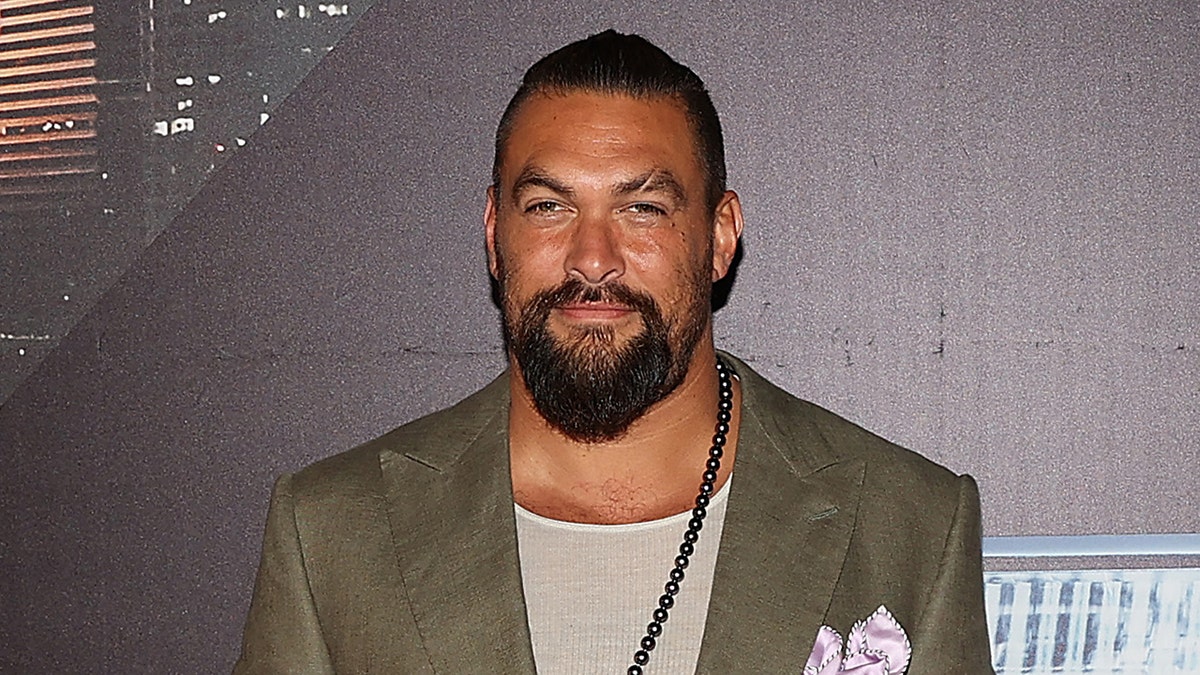Jason Momoa on red carpet.