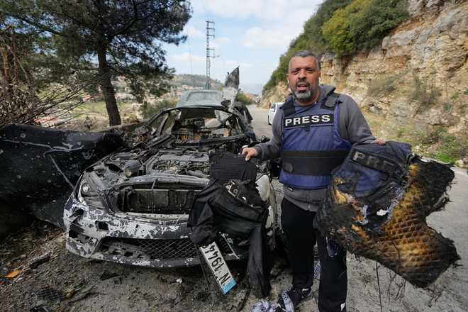 Journalist A journalist carries burned safety gear, following an Israeli airstrike on a car that killed Hezbollah's al-Manar TV correspondent Ali Shoeib, Beirut's based Al-Mayadeen TV reporter Fatima Ftouni and her brother, video journalist Mohammed Ftouni, in the town of Jezzine, south Lebanon, Saturday, March 28, 2026.