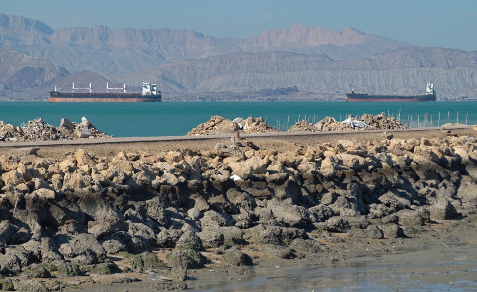 large cargo and tanker ships at shahid rajai port from qeshm island pier, persian gulf, iran