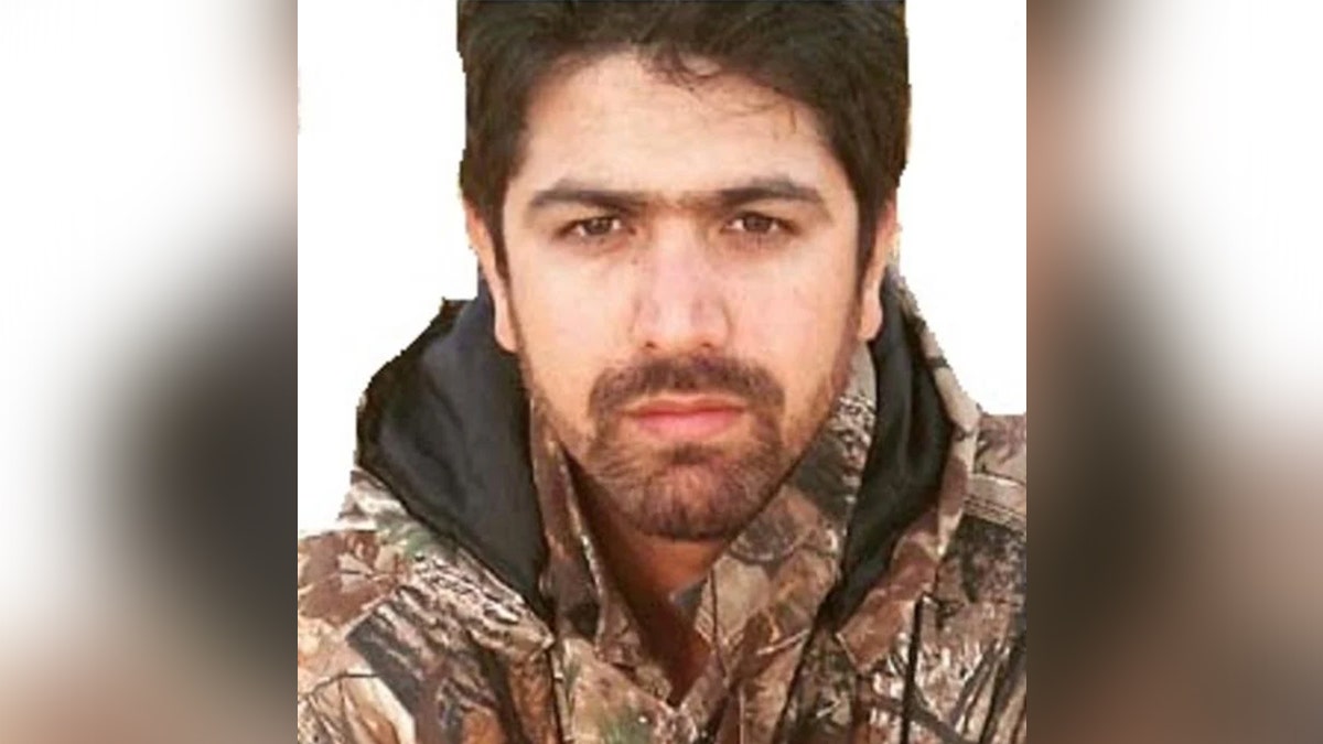 photo of MEHDI FARHADI wearing camouflage sweater