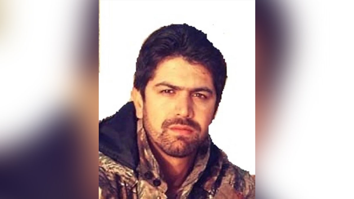 photo of MEHDI FARHADI wearing camouflage sweater