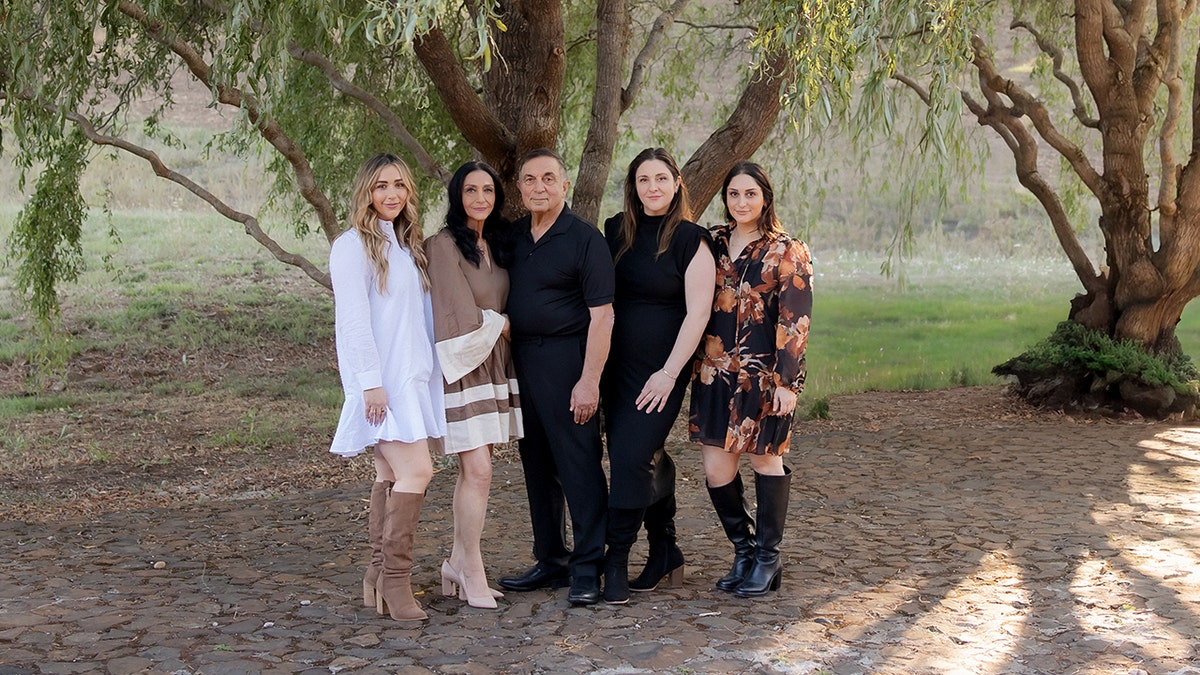Moe Momtazi, center, poses with his wife, second from left, and three daughters.