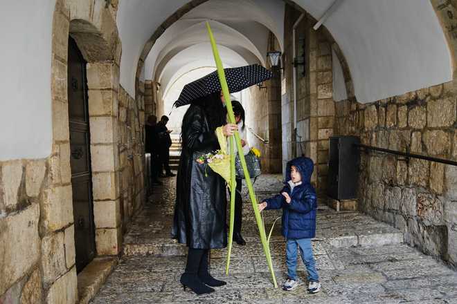 Palm Sunday Christians walk with palm branches during Palm Sunday in Jerusalem's Old City, Sunday, March 29, 2026.