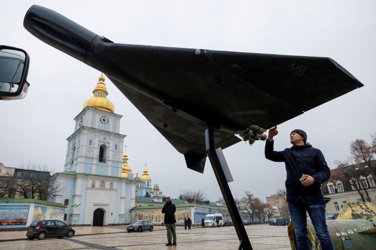 FILE PHOTO: A resident touches a Russian-Iranian Shahed-136 (Geran-2) kamikaze drone installed in front of Saint Michael's Cathedral as a part of an exhibition displaying destroyed Russian military vehicles and weapons, amid Russia's attack on Ukraine, in Kyiv, Ukraine November 26, 2025. REUTERS/Valentyn Ogirenko/File Photo