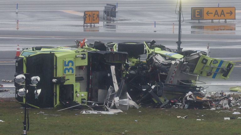 The fire engine was knocked on its side. Pic: Reuters