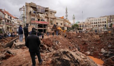 People inspect the damage where Israel's military carried out an airborne operation that dropped troops in Nabi Chit. Pic: Reuters