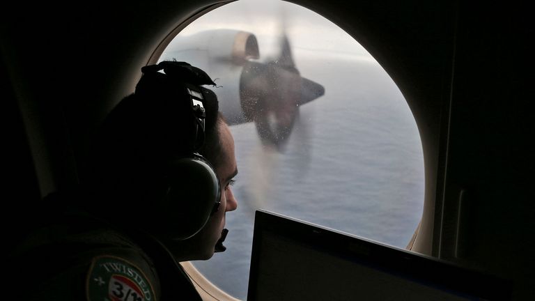 An Australian flight officer scans the waters of the southern Indian Ocean during a search for the missing MH370 in 2014. Pic: AP