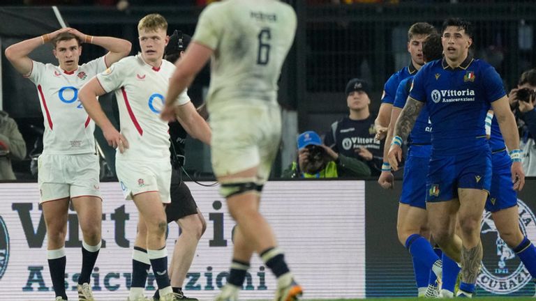England's players stand on the pitch as Italy's Leonardo Marin celebrates after scoring a try during the Six Nations rugby union match between Italy and England in Rome, Saturday, March 7, 2026. (AP Photo/Gregorio Borgia)
