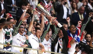 Sunderland's Luke O'Nien, Daniel Neil and manager Regis Le Bris lift the EFL Championship play-off trophy