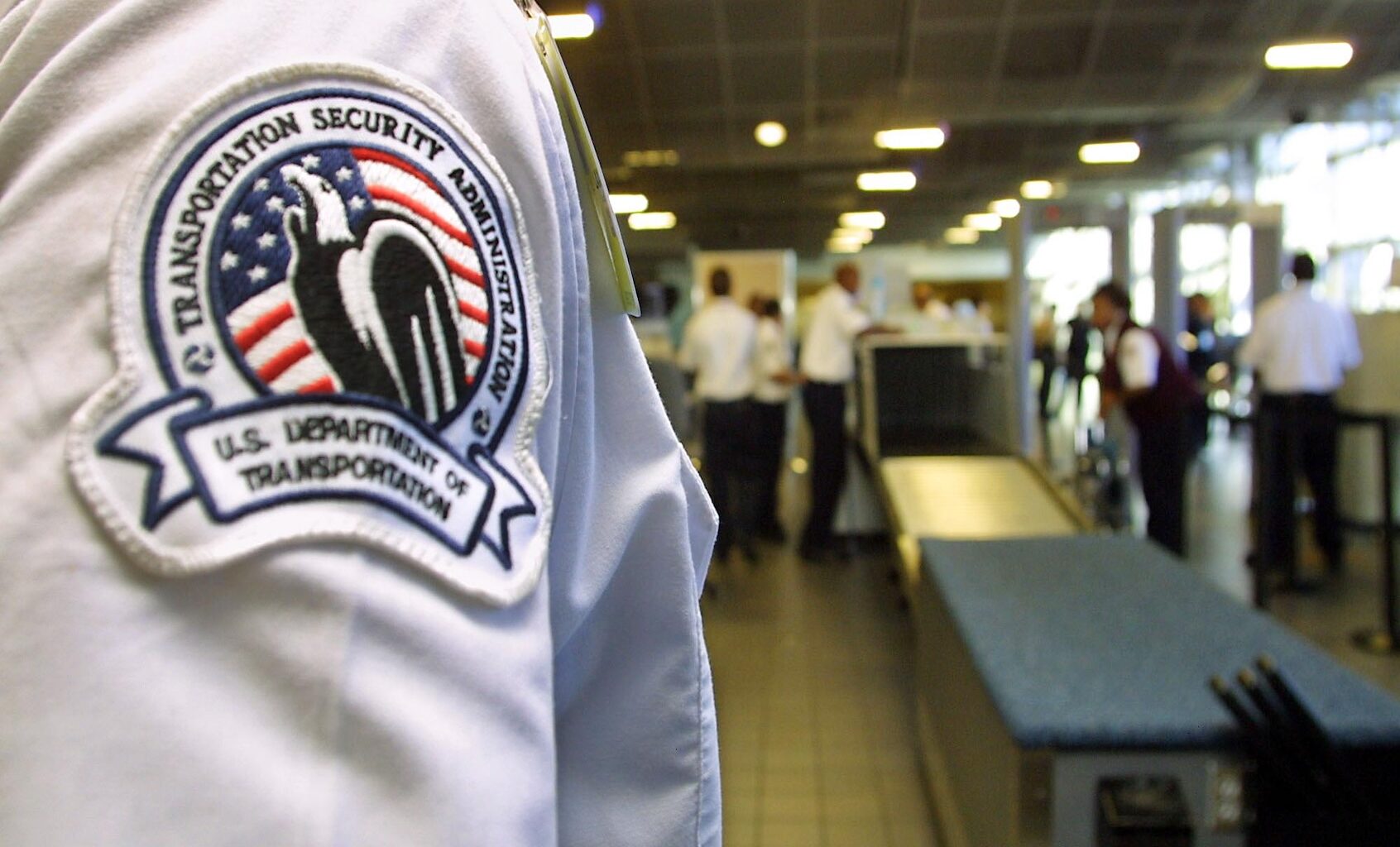 A Transportation Security Administration officer looks over passenger security checkpoint during a tour of the Emergency Preparedness and Domestic Security Program at Los Angeles International Airport 06 March 2003. (Photo by LEE CELANO/AFP via Getty Images)