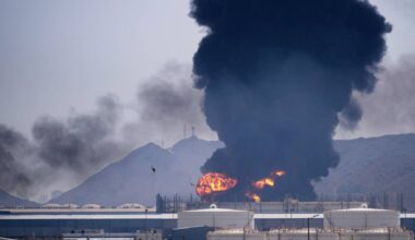 A fire and plume of smoke rise after, according to authorities. debris from an intercepted Iranian drone struck an oil facility in Fujairah, United Arab Emirates, Saturday, March 14, 2026.(AP Photo/Altaf Qadri)