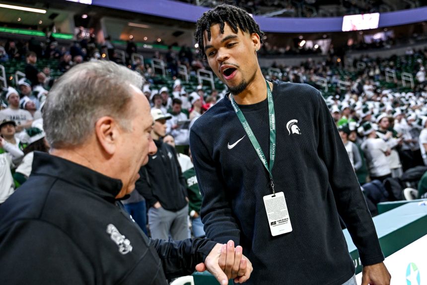 Malik Hall greets his former Michigan State head coach, Tom Izzo, while visiting the Breslin Center in February 2025.