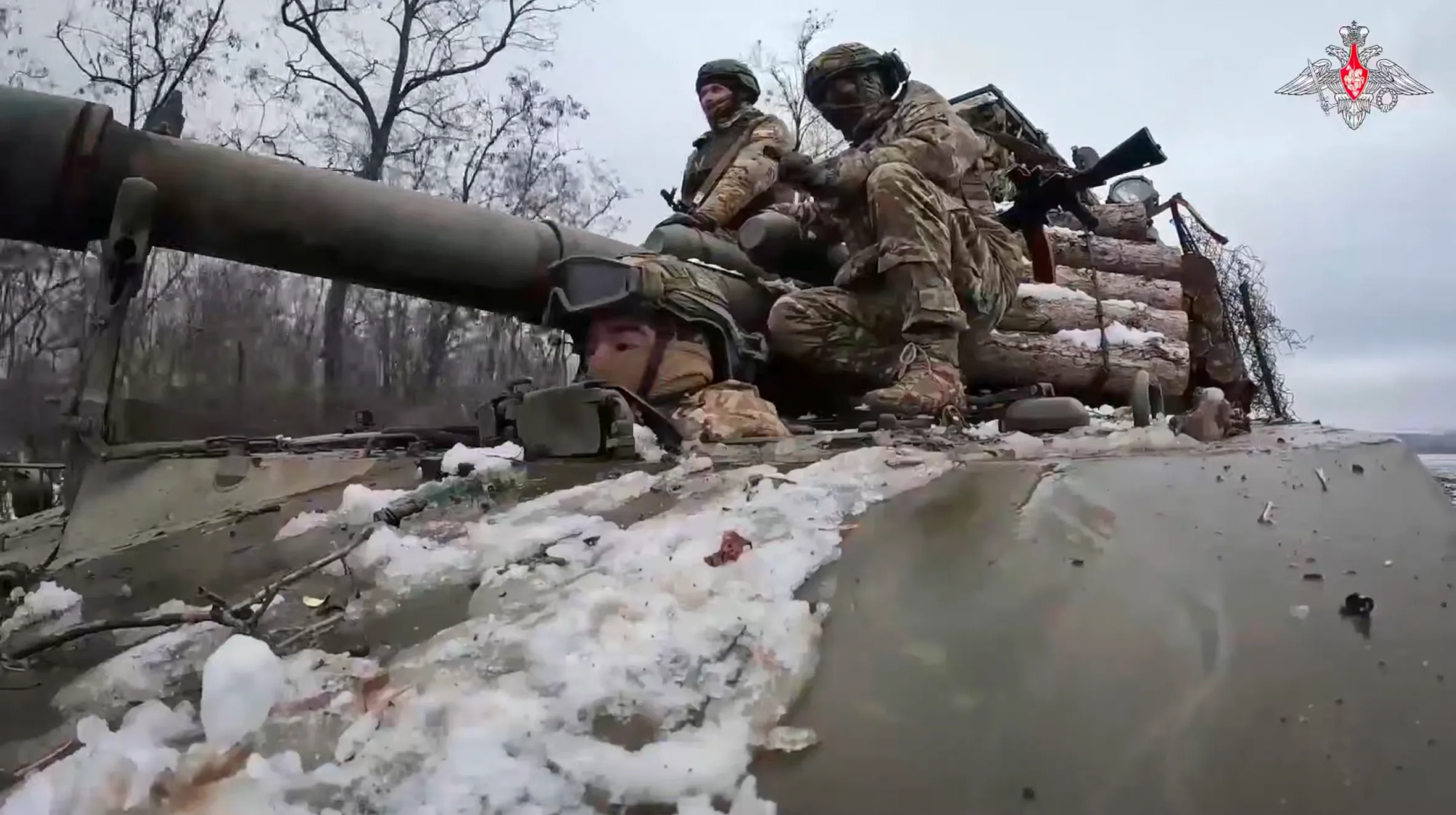 Russian soldiers ride atop an Akatsyia self-propelled gun.