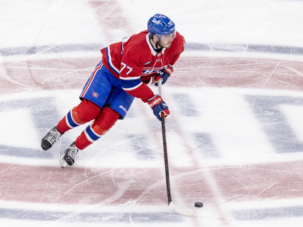 Canadiens' Kirby Dach skates with the puck at centre ice at the Bell Centre.