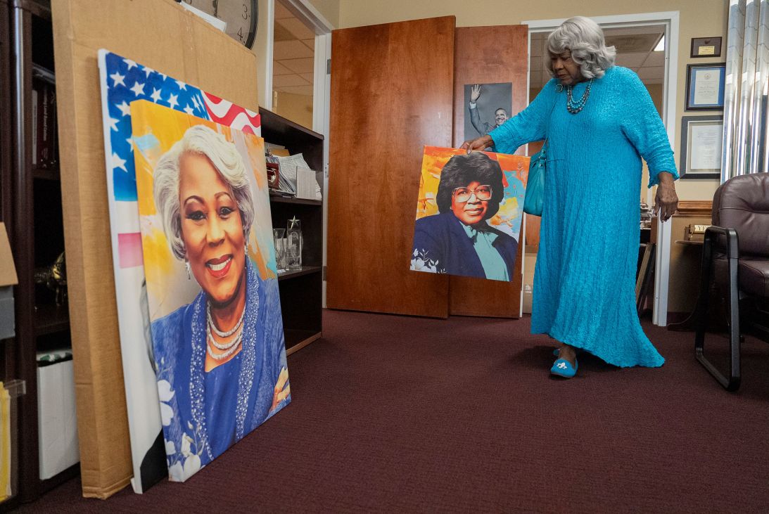 Lucas moves art in her office.