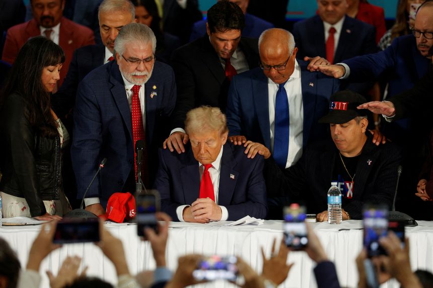 Latino community leaders pray for then-candidate Donald Trump during a roundtable in Doral, Florida, on October 22, 2024.