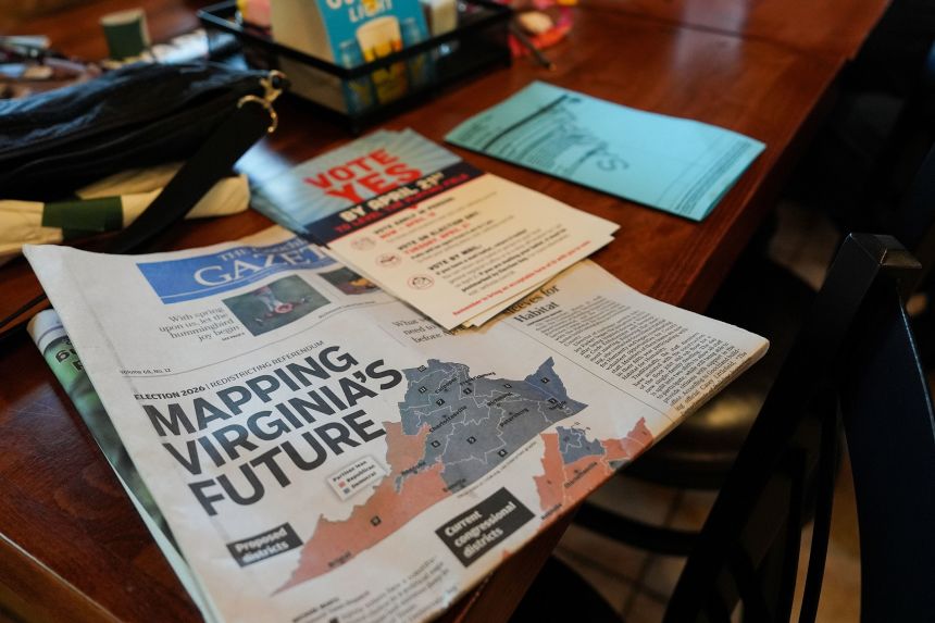 A print edition of the Goochland Gazette, with a front page story on the Virginia redistricting referendum, lies on a table at GG's Pizza in Maiden, Virginia, on April 2, as members of the Goochland Democratic Committee hold a lunch meeting on get-out-the-vote efforts.