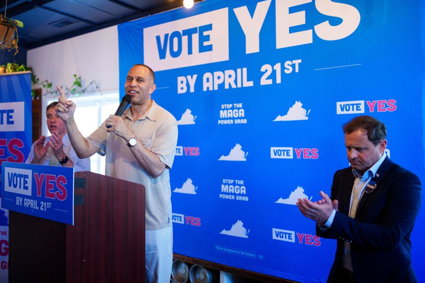 House Minority Leader Hakeem Jeffries is flanked by Sen. Mark Warner, left, and congressional candidate Tom Perriello, as Jeffries speaks at the Virginians for Fair Elections rally in Charlottesville, Virginia, on April 11.