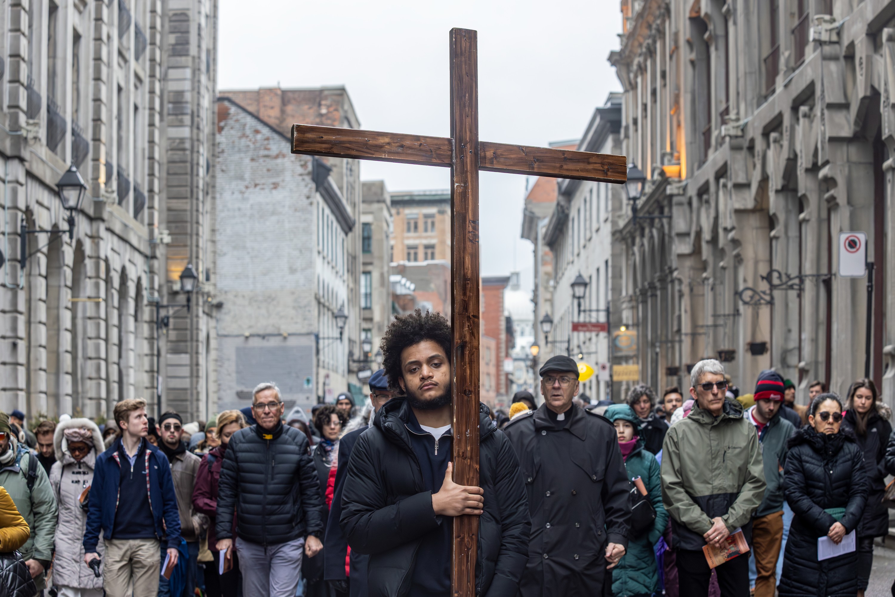 A man carries a cross during the Way of the Cross march in Montreal on Good Friday.