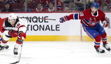 Canadiens defenceman Lane Hutson high-sticks New Jersey Devils winger Connor Brown during second period in Montreal on Sunday.