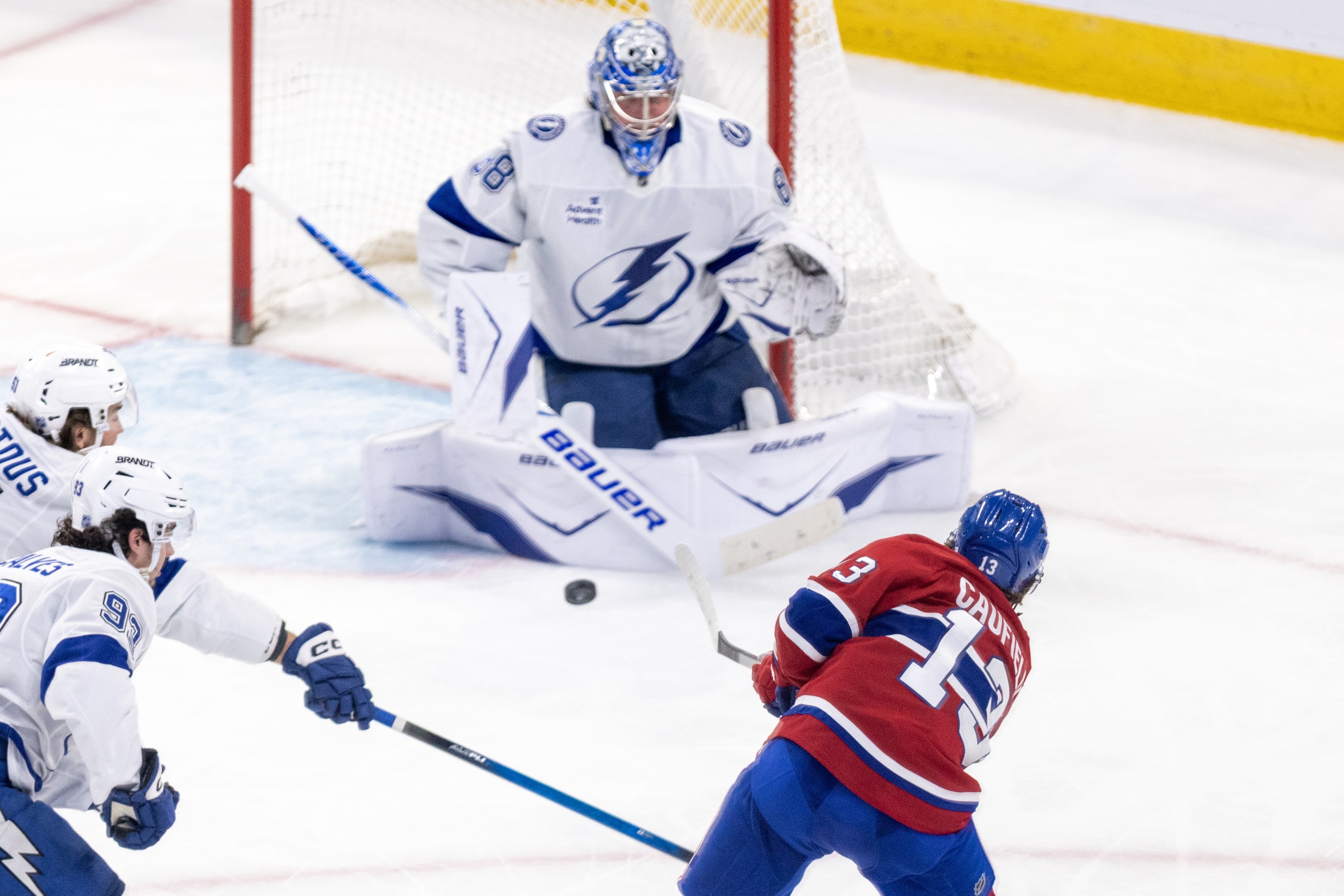 Hockey player shoots the puck past the goalie.