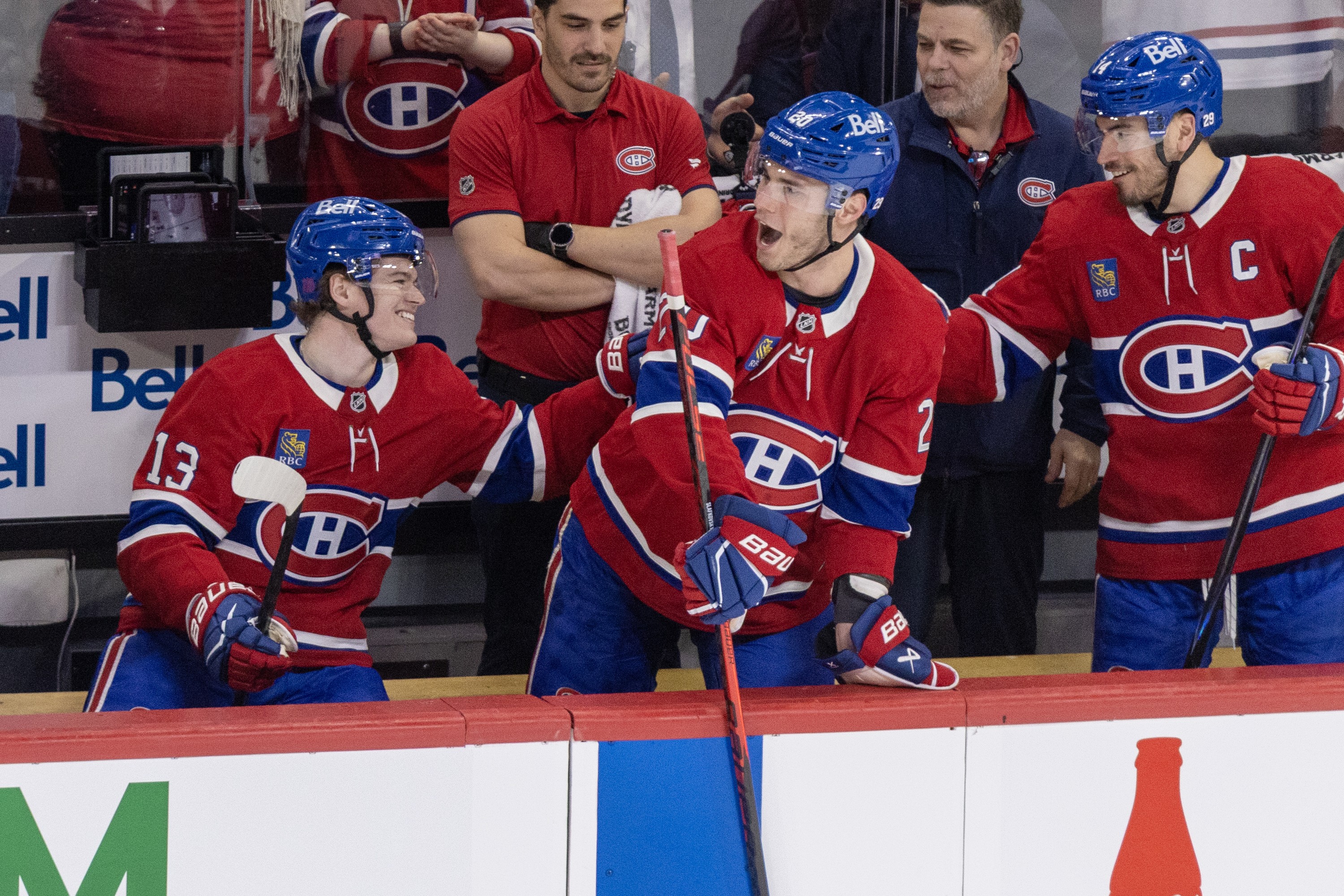 Canadiens' Juraj Slafkovsky leads the cheers for Cole Caufield, left, with linemate Nick Suzuki joining in after Caufield scored his 50th goal of the season during second period against the Tampa Bay Lightning in Montreal on Thursday.