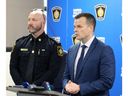 Deputy Sarnia police chief Michael Van Sickle, left, watches the crowd as Det. Sgt. Kent Jamieson, right, speaks during a news conference Friday at headquarters about a shooting at Lambton College that left a 20-year-old junior hockey player dead and injured two others. (Terry Bridge/Sarnia Observer)