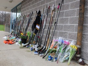row of hockey sticks, along with flowers, jerseys