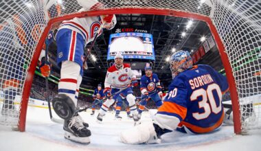 Canadiens captain Nick Suzuki, centre, scores a goal for his 100th point of the season during second period against Islanders