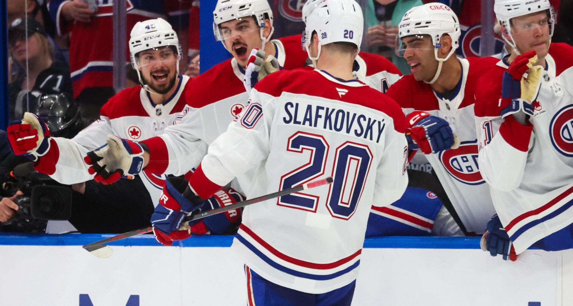 Montreal Canadiens left wing Juraj Slafkovsky celebrates a goal with teammates.