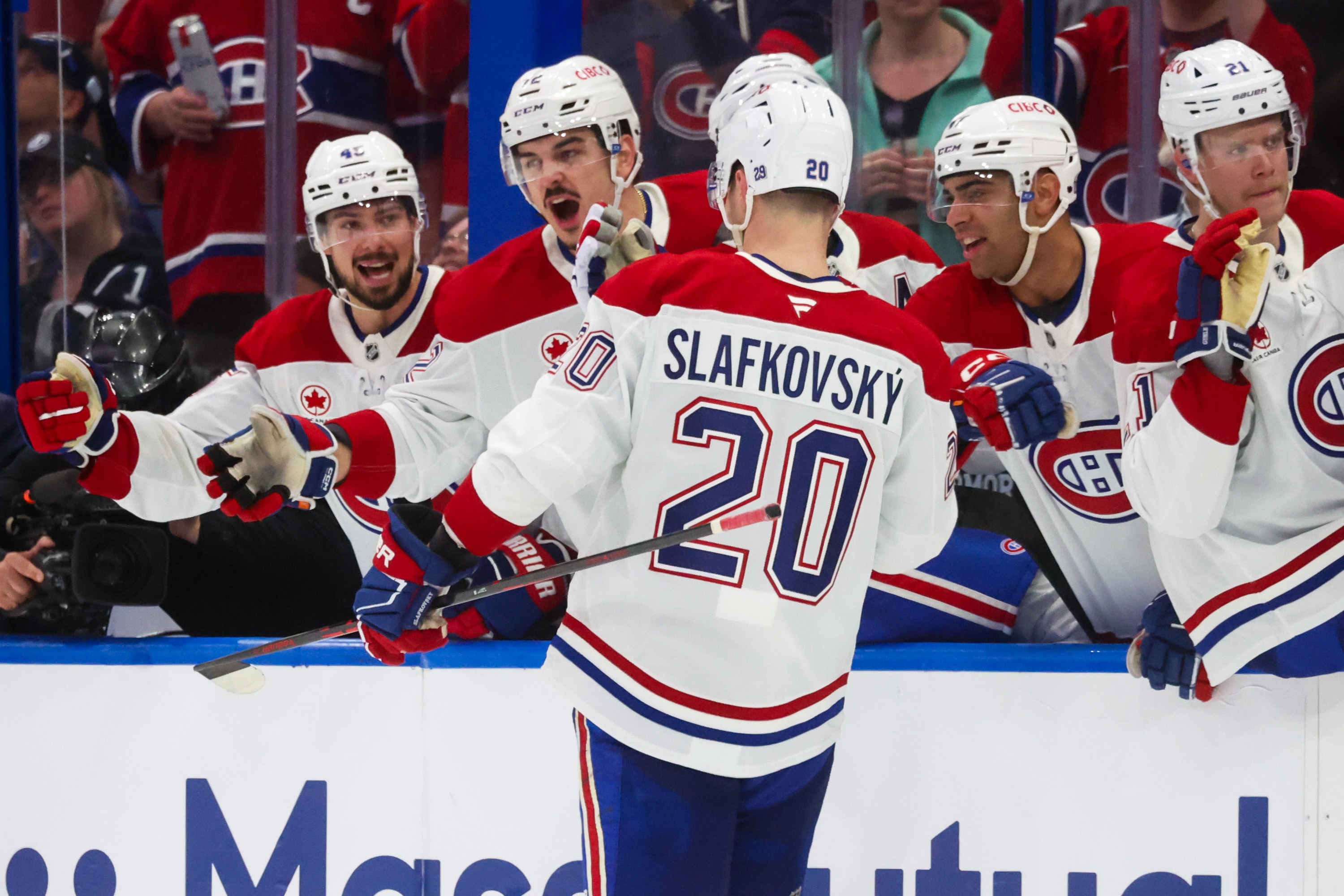 Montreal Canadiens left wing Juraj Slafkovsky celebrates a goal with teammates.