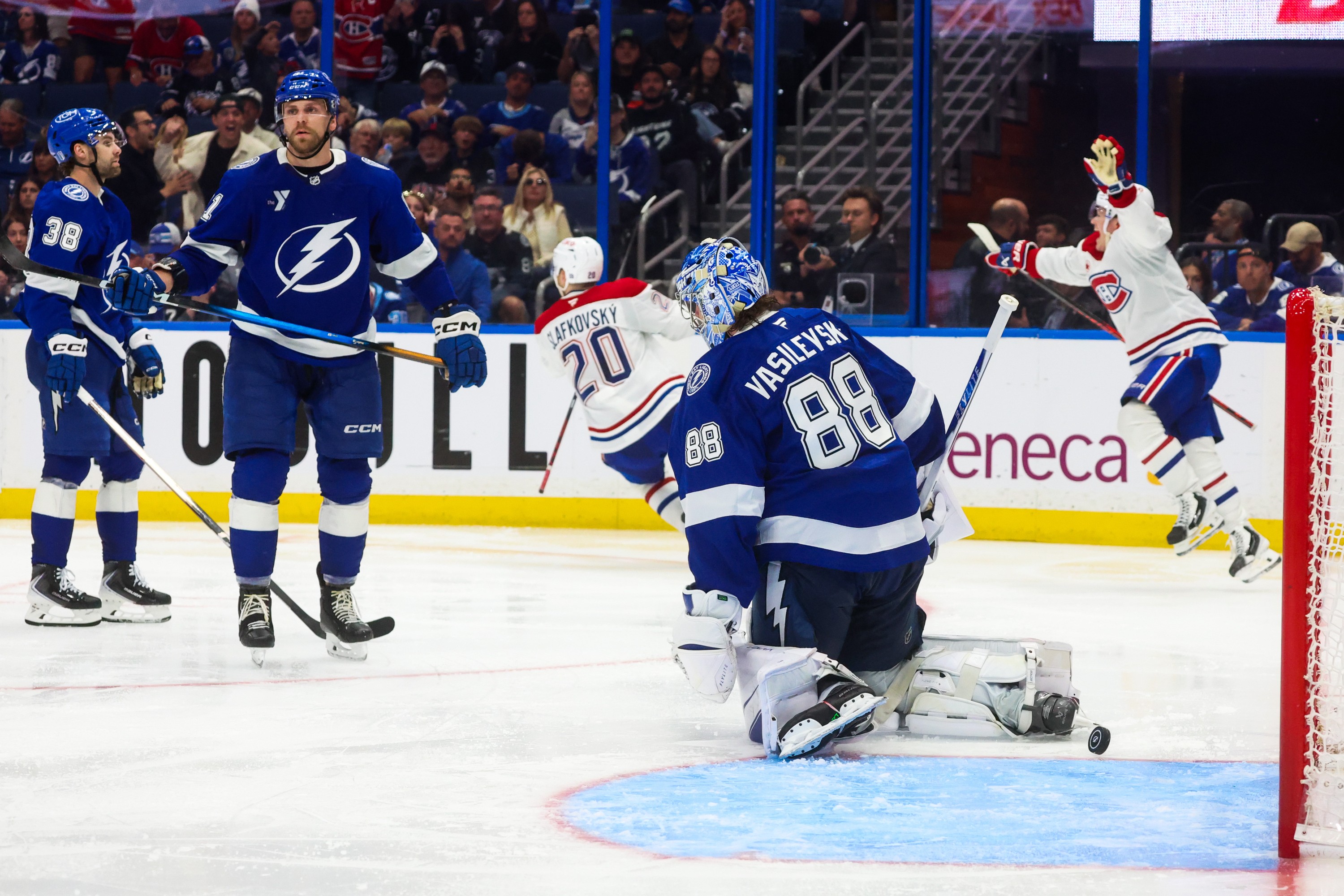 Tampa Bay Lightning left wing Brandon Hagel, defenceman Erik Cernak and goaltender Andrei Vasilevskiy look on as Montreal Canadiens left wing Juraj Slafkovsky and Canadiens right wing Cole Caufield celebrate a goal.