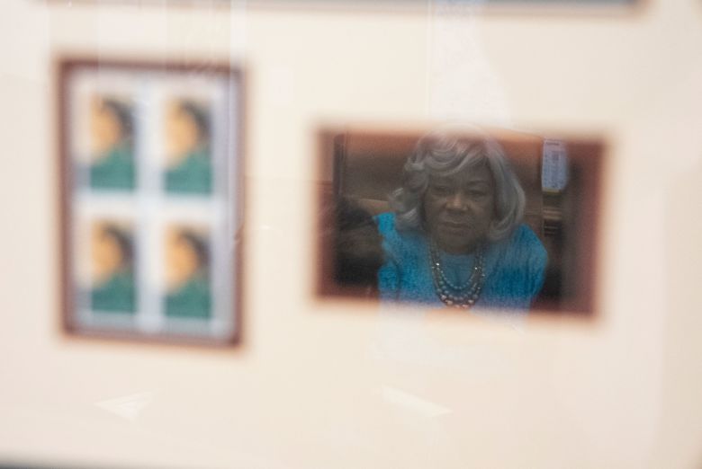 Lucas is reflected in a piece honoring Rosa Parks at her office.