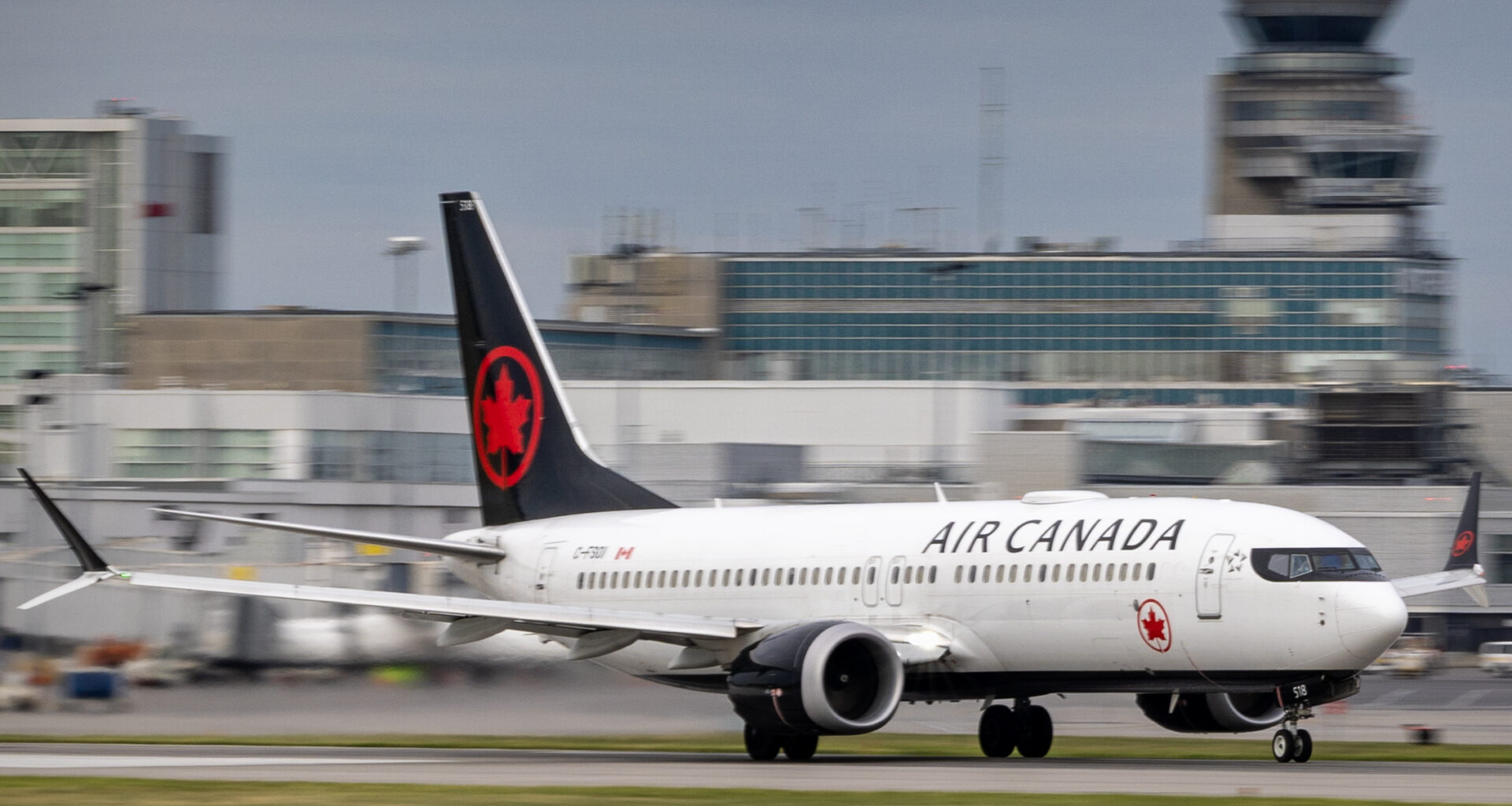 A jet plane speeds down the runway ahead of takeoff