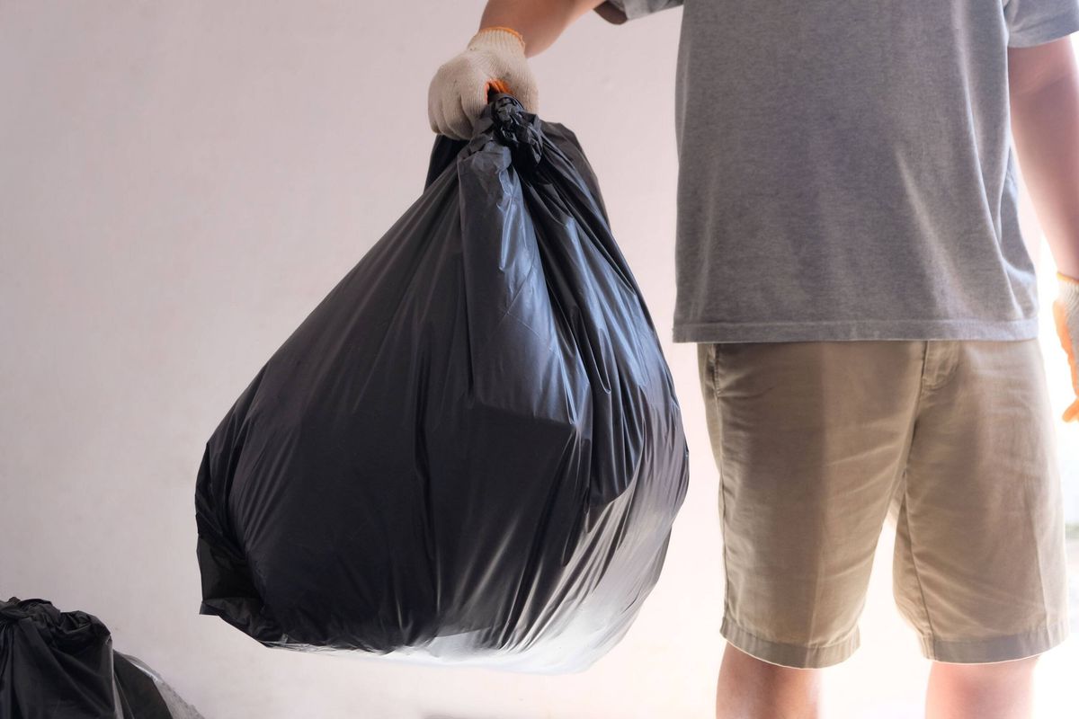 A man holding a garbage bag