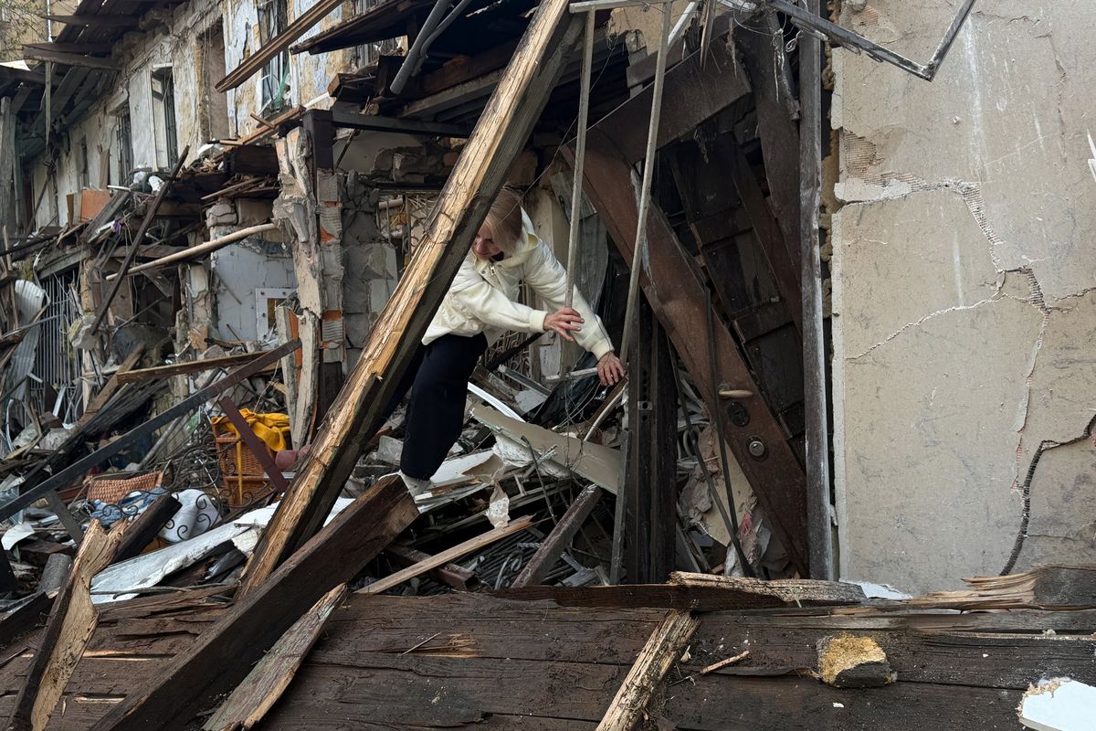 People clear the debris after a Russian overnight attack