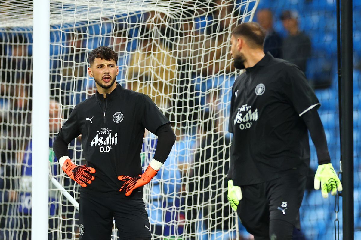 Manchester City goalkeepers James Trafford and Gianluigi Donnarumma warm up together