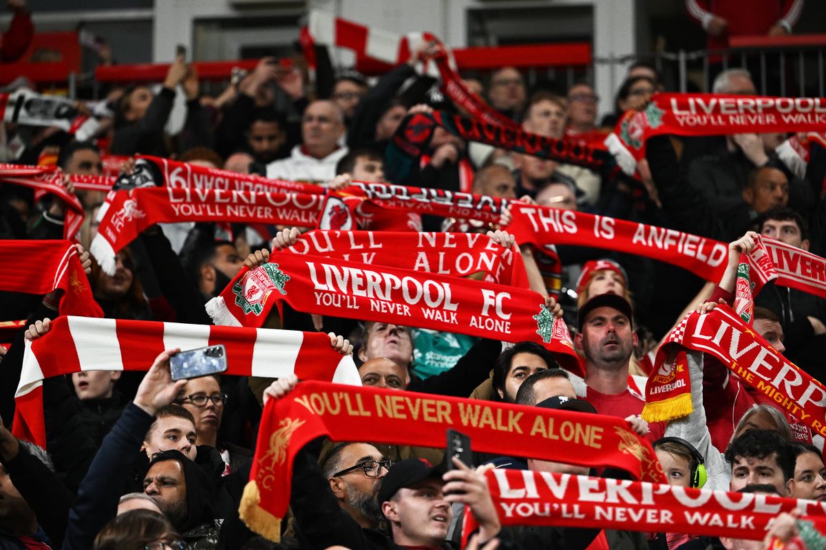 Liverpool fans hold up scarves