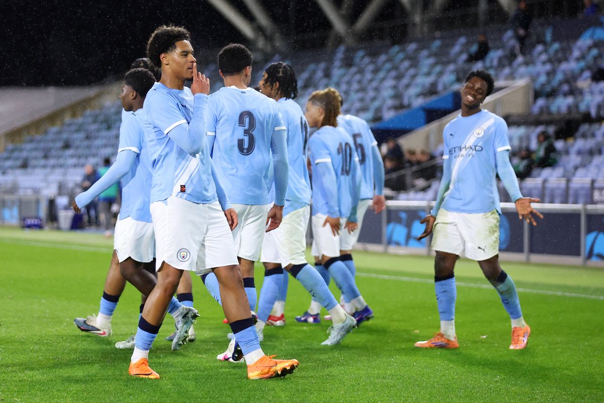 Floyd Samba of Manchester City celebrates with team mates after scoring his side's first goal from the penalty spot during the FA Youth Cup Quarter Final match between Manchester City and Everton at Joie Stadium