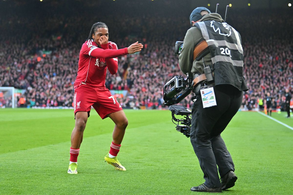 Liverpool's English striker #73 Rio Ngumoha celebrates for the TV camera after scoring the opening goal of the English Premier League football match between Liverpool and Fulham at Anfield